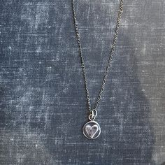 "This nickel-sized solid sterling silver heart pendant is a great way to bring you or a loved-one a virtual hug. The perfect gift. May request up to 3 initials stamped on the back (request in notes). Cast from recycled sterling silver scrap metal. Available in 16\" & 18\" length (make your selection at check out) on an oxidized (antiqued) flat figaro style chain." Sterling Silver Hand Stamped Heart Charm Necklace, Sterling Silver Double Heart Engraved Charm Necklace, Hand Stamped Heart Sterling Silver Charm Necklace, Silver Open Heart Keepsake Charm Necklace, Silver Open Heart Charm Necklace For Keepsake, Sterling Silver Hand Stamped Heart Pendant Necklace, Hand-stamped Sterling Silver Heart Pendant Necklace, Sterling Silver Hand Stamped Heart Necklace, Hand Stamped Sterling Silver Heart Pendant Necklace