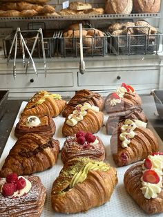 there are many croissants and pastries on the counter