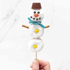 a snowman made out of marshmallows on a stick