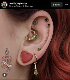 a woman with red hair and piercings on her ear