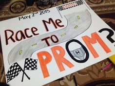 a sign that says race me to prom? on the floor next to a pen and marker