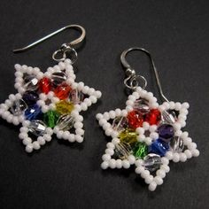 a pair of colorful beaded earrings sitting on top of a table