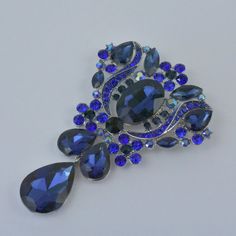 "Beautiful large unique and very sparkly crystal Rhinestone brooch Perfect for various DIY projects such as brooch bouquet, brooch flower boutique, wedding dress, cake decoration, wedding invitation items, guest book, evening gowns, fascinating hat , clutch Christmas and more.... Approx. size - 3 3/4\"L X 2 1/2\"W Stone -Rhinestone crystal Back - pin back Base Metal - Silver Color - Royal blue All our Items are NEW!! and ready to ship same day as you purchase. RETURNS, REFUNDS & SHIPPING: Al Royal Blue Wedding Cakes, Dressy Earrings, Bridal Mask, Crystal Chandelier Earrings, Cake Accessories, Flower Boutique, Wedding Cakes Blue, Royal Blue Wedding, Wedding Brooch