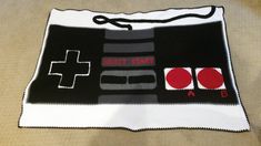 a black and white knitted blanket with red buttons