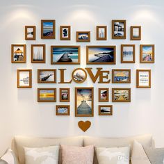 a living room filled with furniture and framed pictures on the wall above a love sign