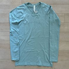 - Lululemon Swiftly Tech Long Sleeve 2.0 - Color: Hazy Jade (Hzja) - Light Blue, Teal - Silverescent Technology - Size 8 - Slim Fit, Hip Length - Thumb Holes - Seamless Fabric Minimizes Chafing - Mesh In Back For Extra Breathability - Motivational Words On Inside Of Hem: “Movement Is Medicine,” “Breathe. Repeat.” - New Without Tag, Nwot, Never Worn, No Flaws. Bought Too Many Of This Style And Never Wore This One. - 54% Nylon, 40% Recycled Polyester, 3% Elastane, 3% X-Static Nylon - Also Selling Light Blue Long Sleeve Athleisure Activewear, Movement Is Medicine, Lululemon Long Sleeve Shirts, Anna Claire, Lululemon Swiftly Tech Long Sleeve, Swiftly Tech Long Sleeve, Lululemon Long Sleeve, Lululemon Running, American Flag Sweater