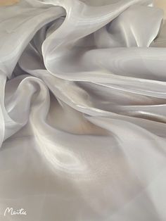 the white fabric is very soft and smooth, but it doesn't look like silk