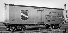 black and white photograph of an old train car on railroad tracks with the name armidals restaurant