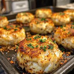 cooked scallops on a baking sheet with parsley