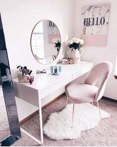 a white desk topped with a mirror next to a chair