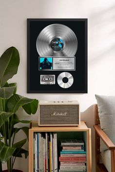 a record player sitting on top of a table next to a plant