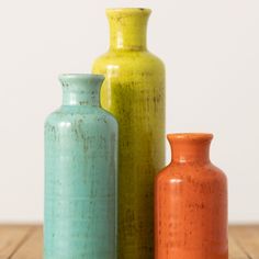 Ceramic bottle set measuring 5", 7.5" and 10" accordingly. All three colorful pieces feature 1" openings perfect for a favorite stem or to simply stand alone. Over the last 55 years, Sullivans has become an industry leader in home decorations. Our brand is rooted in tradition while incorporating modernized trends to keep your home looking up to date with timeless style. Here at Sullivans, we pride ourselves on creating product designs focused on quality and value, ensuring that our customers hav Colorful Tablescapes, Bottle Shapes, Teal Vase, Farmhouse Vase, Clay Artists, Bags Sewing, Striped Vase, Colored Vases, Rustic Vase