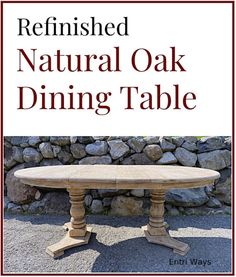 a table that has been refinished and is sitting in front of a stone wall