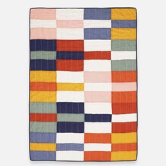 a multicolored quilt on a white background