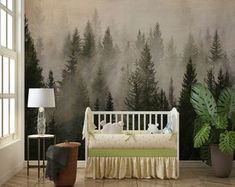 a baby's crib in front of a forest mural