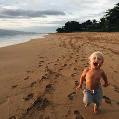 an older man is walking on the beach with his mouth open and footprints in the sand