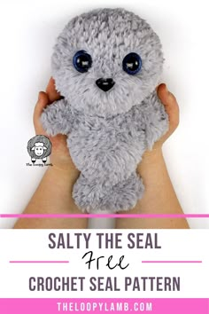 a hand holding a gray stuffed animal with the words salty the seal free crochet seal pattern