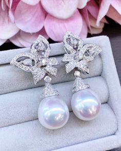 We are presenting you a HUGE pair of CHANDELIER, Genuine, PURE White South Sea Pearls, extremely FINE AA+, LUSTROUS and Rare! Accenting the 2 pearls are 156 pieces of F/VS Natural diamonds, weighting a total of 1.96 carats. Set in fabulously designed 18K solid white gold earrings. Perfect dangling style! Perfect for formal events and cocktail parties!  ONLY ONE ITEM AVAILABLE!! NO DUPLICATES!! WHAT YOU SEE IN THE PICTURES IS WHAT YOU WILL GET SOLIDLY HANDCRAFTED EARRINGS! SUGGESTED RETAIL VALUE: Luxury White Pear-shaped Pearl Earrings, Luxury Pear-shaped Earrings For Evening, Luxury White Pear-shaped Bridal Earrings, Luxury Diamond Dangle Pearl Earrings, Luxury White Gold Teardrop Pearl Earrings, Luxury White Diamond Pear-shaped Earrings, Luxury White Pear-shaped Diamond Earrings, Luxury White Pear Shaped Diamond Earrings, Luxury Dangle Bridal Earrings