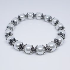 Finish Your Look With This Elegant Stretch Bracelet. It Consists Of Pearl Glass Beads And Silver-Plated Pewter Flower Bead Caps. It Has A Secure Fit. Bracelet Measurements - 7 3/4inches Or 19.7 Cm. Bracelet Measurements, Glass Beaded Bracelet, Jewelry Pearl, Glass Beaded Bracelets, Bead Caps, Beaded Flowers, Stretch Bracelet, Stretch Bracelets, Pearl Jewelry