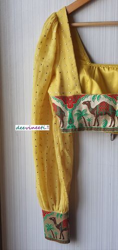 This Made to Order/Made to Measurement/Custom Made Indian Ethnic Blouse. - Fabric - Mul Cotton with Gold Mukaish Dots - Color - Yellow - Padded - Princess Cut - U Neck - Puffed Full Length Sleeves with Multicolor Border - Back Hook Closure - Border at the back Fabric Care : Dry Clean Only Disclaimer: The actual color of the product might slightly differ from the image due to photographic lighting or monitor's display Shipping: This is made to order product. Once you place the order we will provi Bohemian Blouse With Traditional Drape For Eid, Bohemian Chanderi Blouse For Wedding, Yellow Long Sleeve Choli For Eid, Bohemian Chanderi Blouse For Eid, Fitted Yellow Blouse Piece For Eid, Bohemian Chanderi Blouse For Festive Occasions, Yellow Festive Blouse For Eid, Yellow Choli With Motifs For Eid, Bohemian Blouse With Self Design For Eid