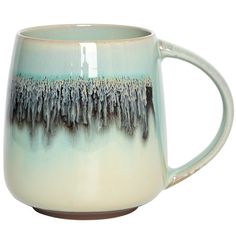 a coffee mug with an abstract design on the outside and inside, sitting on a white surface