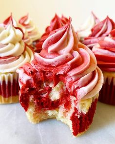 red velvet cupcakes with white frosting and sprinkles