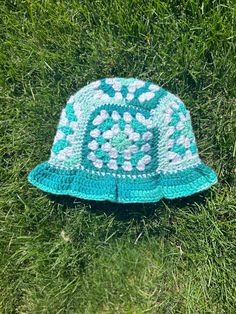 Handmade granny square bucket hat that is perfect for summer! This hat is made with acrylic yarn. This  design was inspired by @stellarthreadsbymadison on instagram Summer Granny Square Crochet Bucket Hat, Summer Granny Square Yarn Hats, Handmade Retro Crochet Hat For Summer, Handmade Retro Bucket Hat For Summer, Retro Handmade Bucket Hat For Summer, Handmade Retro Summer Bucket Hat, Handmade Green Bucket Hat For Summer, Trendy Handmade Green Crochet Hat, Handmade Green Summer Bucket Hat