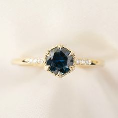 This ring is made to order. Please contact us if you wish to pick the center-stone from our loose inventory Peacock green sapphire, approximately 0.75-0.85ct., 5.5mm, eye clean, mined in Queensland Australia 0.02ctw G color SI clarity accent diamonds Band width: approx. 1.4mm Low profile six prongs setting Made of 100% recycled solid 14k gold and ethically sourced gemstones About This Ring Minimalistic design with the right amount of sparkles, Grace Ring is loved for its modern elegance in its s Engagement Ring Low Profile, Low Profile Engagement Ring, Ring Redesign, Rings With Diamonds, Stackable Birthstone Rings, Birthstone Ring Mothers, Hexagon Ring, Hexagonal Ring, Montana Sapphire Ring