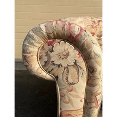 an upholstered chair with flowers on it