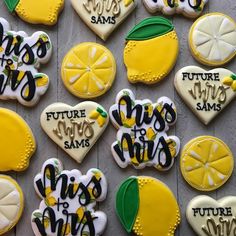 decorated cookies with words and lemons are arranged on a table in the shape of hearts