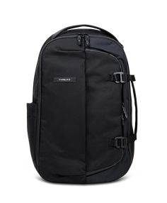 a black backpack with straps on the front and side pockets, sitting against a white background