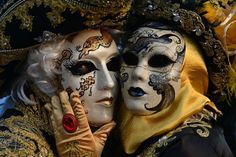 two people with painted faces and masks on