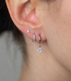 a close up of a person's ear wearing earrings