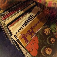 a stack of records sitting on top of a table