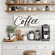 a kitchen with white cabinets and wooden shelves filled with coffee machines, cups and mugs