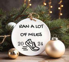 a ceramic ornament with the words ran a lot of miles on it next to christmas ornaments