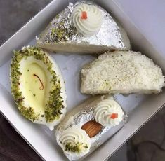 an open box with three desserts in it