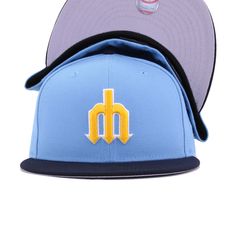 Although the Mariners started wearing Sky Blue uniforms in 1977, the color never actually showed up on hats. Until now. Two-tone looks with Ombre Gold front makes this Mariners fitted a must-have for fans, while being extremely stylish for everyday wear. With clean lines and presentation throughout, this unusually colored hat makes it surprisingly easy to grab and go with just about anything you’re wearing. Hat Material: 100% Polyester/WoolCrown: Sky BlueVisor: NavyButton: NavyUndervisor: GreyFr Throwback Blue Hats For Sports Events, Navy Flat Bill Hat For Sports Events, Navy Fitted Hat With Flat Bill For Sports Events, Blue Fitted Hat With Curved Brim For Sports Events, Navy Fitted Hat For Sports Events, Throwback Blue Hat With Curved Brim, Navy Flat Bill Fitted Hat For Sports Events, Collegiate Blue Baseball Cap With Flat Brim, Blue Baseball Cap With Flat Brim For Fan Gear