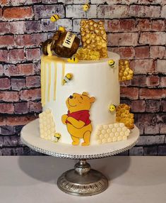 a winnie the pooh birthday cake with honeycombs