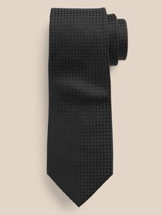 An unequivocally elevated tie, crafted from luxurious, soft silk with a varied texture.  Hand-pressed and shaped for a clean finish.  Measures 3" at widest point.  Length: 58" (147cm) Elegant Silk Neckwear For Office, Black Standard Tie For Business Casual, Luxury Ties For Workwear, Elegant Black Ties For Business Casual, Luxury Standard Tie For Work, Black Suit And Tie Accessories For Business Casual, Elegant Black Business Casual Ties, Elegant Standard Tie For Office, Luxury Black Ties For Office