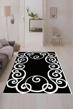 a black and white area rug with swirls on the floor in a living room