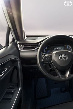 the interior of a car with dashboard, steering wheel and center console area in front of it