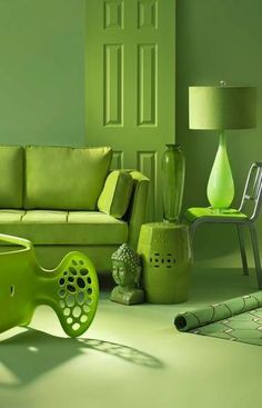 a green living room filled with furniture and decorating items in shades of light green