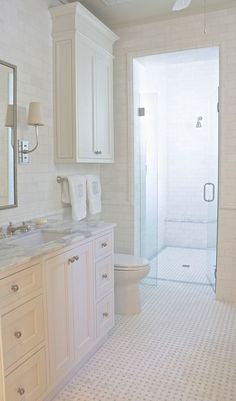 a white bathroom with two sinks and a shower