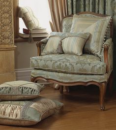 a chair and ottoman in front of a window