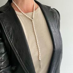 A mesmerizing strand of luminous freshwater pearls ending in silver beads wraps the neck to leave a line of pearls to dangle in front, creating a flattering silhouette. The weathered texture closure, a loop on one side of the strand with a pull-through bar on the other, adds to the unique signature look. Wear it solo or as a key layering piece with other beaded necklaces, chains, or amulet charms. Designed and carefully crafted with a knot between each pearl in our local workshop with attention Long Drop Pearl Necklace, Pearl Pendant Drop Lariat Necklace, Pearl Drop Lariat Necklace, Pearl Lariat Necklace With Pearl Chain, Beaded Lariat Pearl Necklace, Long Drop Pearl Chain Necklace, Long Drop Pearl Necklace With Pearl Pendant, Elegant Beaded Pearl Lariat Necklace, Pearl Drop Long Lariat Necklace