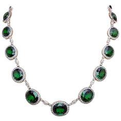 Magnificent platinum necklace. This necklace is designed with 22 oval Chrome Tourmalines. Each stone is framed with round brilliant Diamonds. A single marquis and two round brilliant Diamonds are the connectors. The total length of the necklace is 16-3/4" long. 22 Chrome Tourmalines = 70.11 carats Round Diamonds = 5.83 carats Marquis Diamonds = 1.64 carats Stamped Plat Formal Emerald Necklace With Brilliant Cut, Oval Cubic Zirconia Necklaces For Formal Occasions, Formal Round Diamond Necklace With Gemstones, Luxury Emerald Necklace With Brilliant Cut, Luxury Round Brilliant Cut Emerald Necklace, Formal Oval Emerald Necklace With Diamond Accents, Oval Emerald Necklace With Diamond Accents For Formal Occasions, Luxury Oval Link Diamond Necklace For Formal Occasions, Formal Emerald Necklace With Bezel Setting