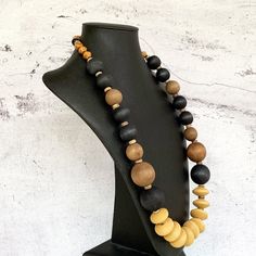 This unique bohemian necklace was hand beaded using a modern mix of large 25mm round mustard yellow wooden rondelles, distressed 28mm and 18mm round wood beads in black and muted brown, a variety of small beige wooden beads, tiny black lava stone rondelles, and black and white agate gemstones.  The necklace measures 31 inches in length and is fastened with a sterling silver toggle clasp.  A unisex necklace that is perfect for any gender!  I guarantee that no one else on the planet will have THIS Bohemian Necklaces With Large Beads For Everyday, Bohemian Necklace With Large Beads For Everyday, Bohemian Everyday Necklace With Large Beads, Unique Everyday Beaded Necklaces, Everyday Bohemian Necklace With Wooden Beads, Artisan Round Bead Necklaces For Everyday, Artisan Necklace With Round Beads For Everyday, Artisan Everyday Necklace With Round Beads, Artisan Necklace With Brown And Black Beads