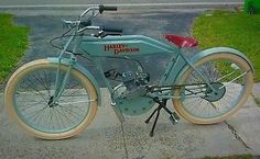 an old blue bicycle is parked on the sidewalk