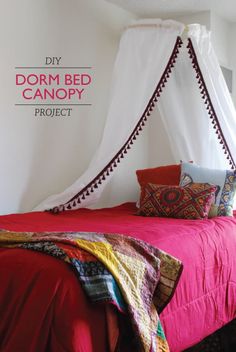 a bed with a canopy over it and pillows on the bottom bunk, in front of a window that reads diy dorm bed canopy project